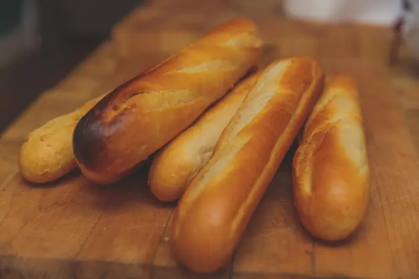 close-up-baguettes-cutting-board_1048944-12453938